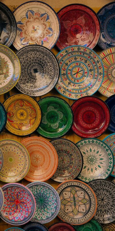 A vibrant collection of handcrafted ceramic plates showcasing intricate designs and vibrant colors.