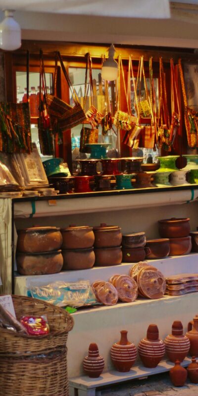 Vibrant market stall showcasing colorful traditional pottery and crafts.